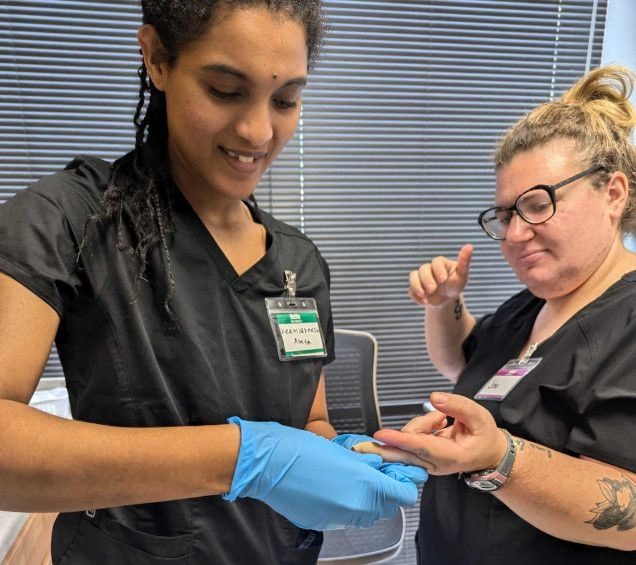 student practicing finger prick for blood draw